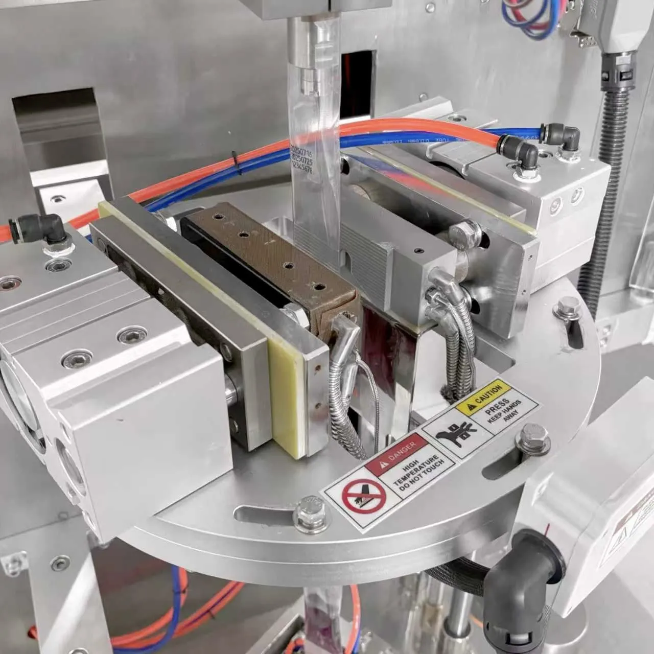 Detail view of liquid filling system and sealing structure of the grape juice packaging machine