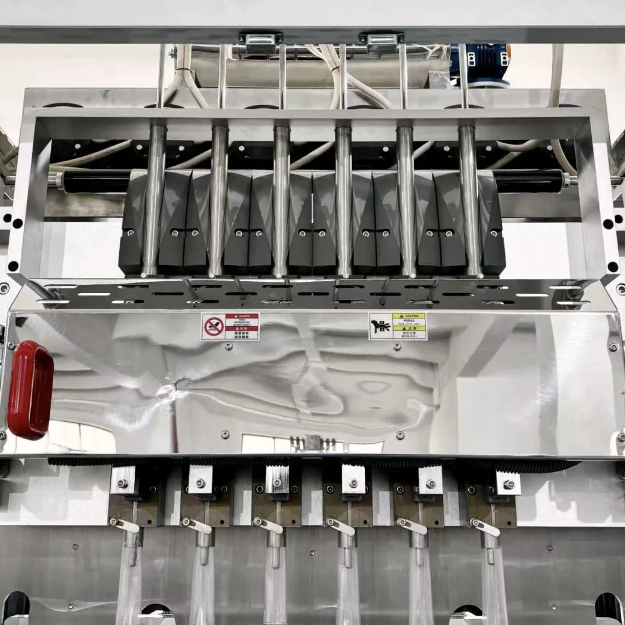 Detail view of the liquid filling screw (auger) system of the ice pop packaging machine