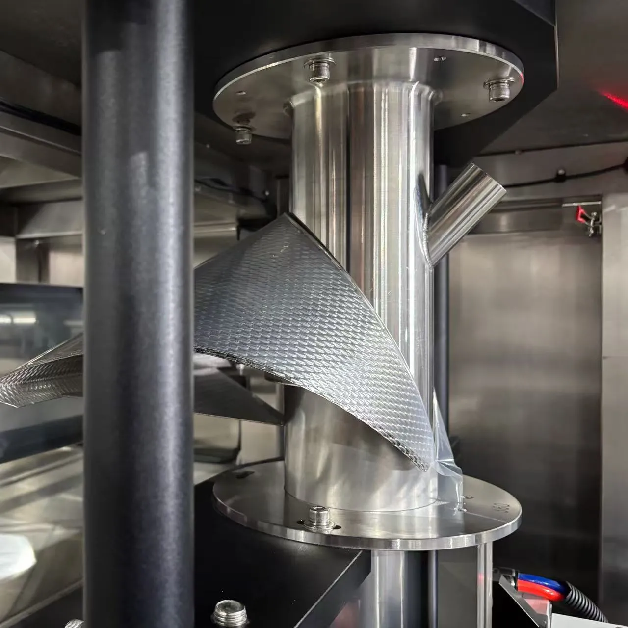 Vertical bag former for powder packaging machine